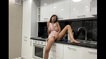 Stunning busty bitch masturbates in the kitchen before her lover arrives